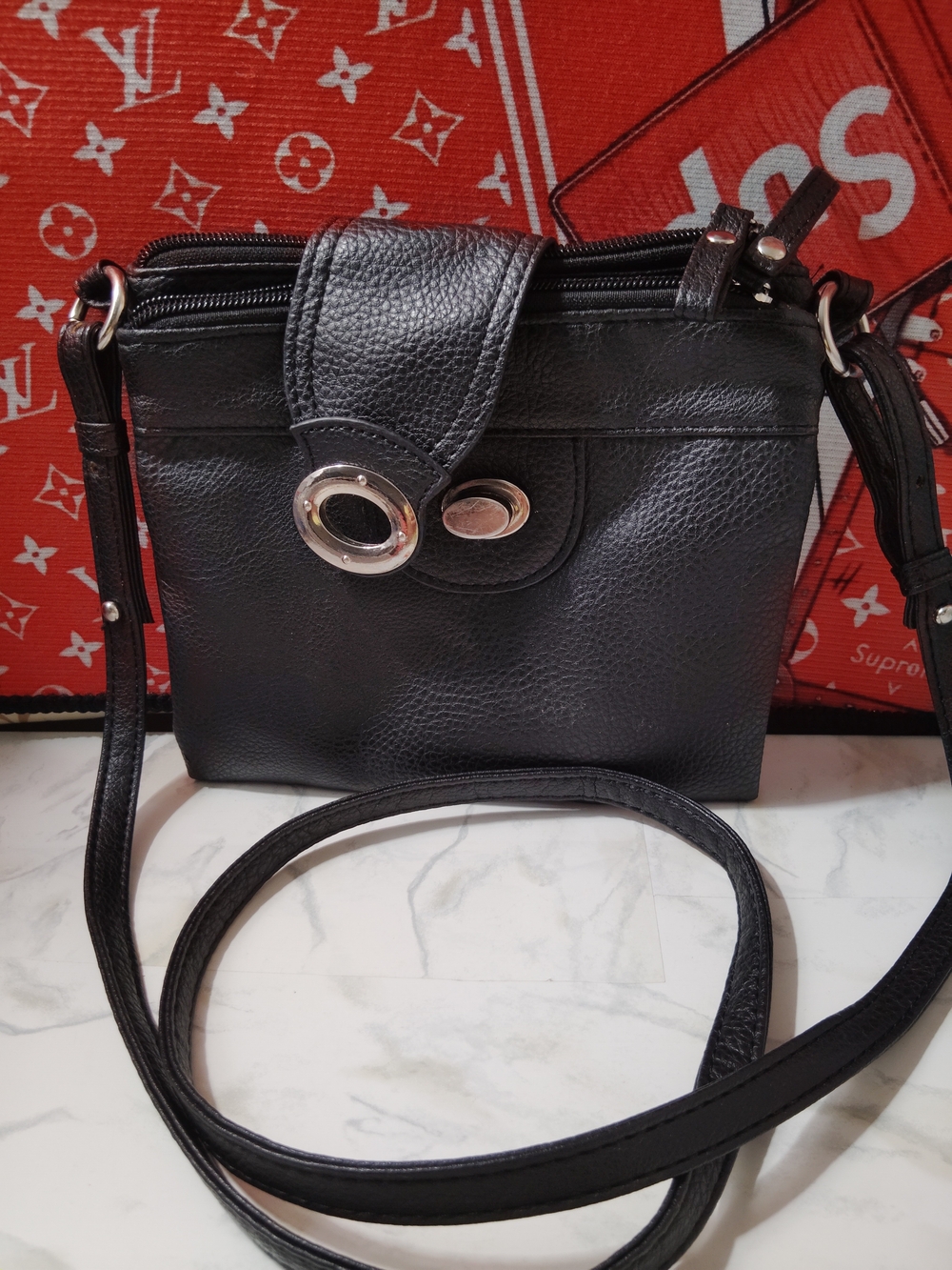 Black Leather Crossbody Bag with Silver Ring Accent Braciano